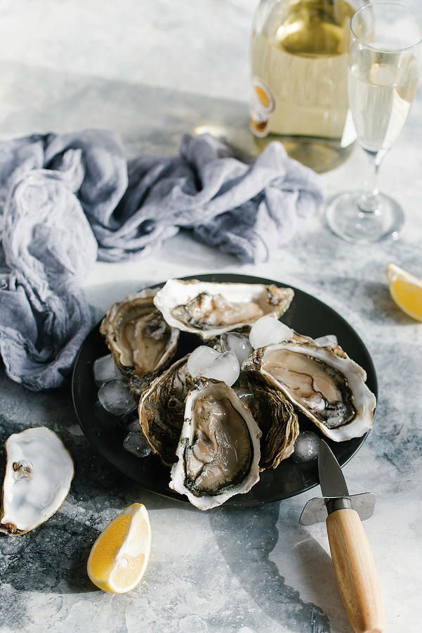 Oysters With Lemon And Champagne Photograph by Kuzmin5d