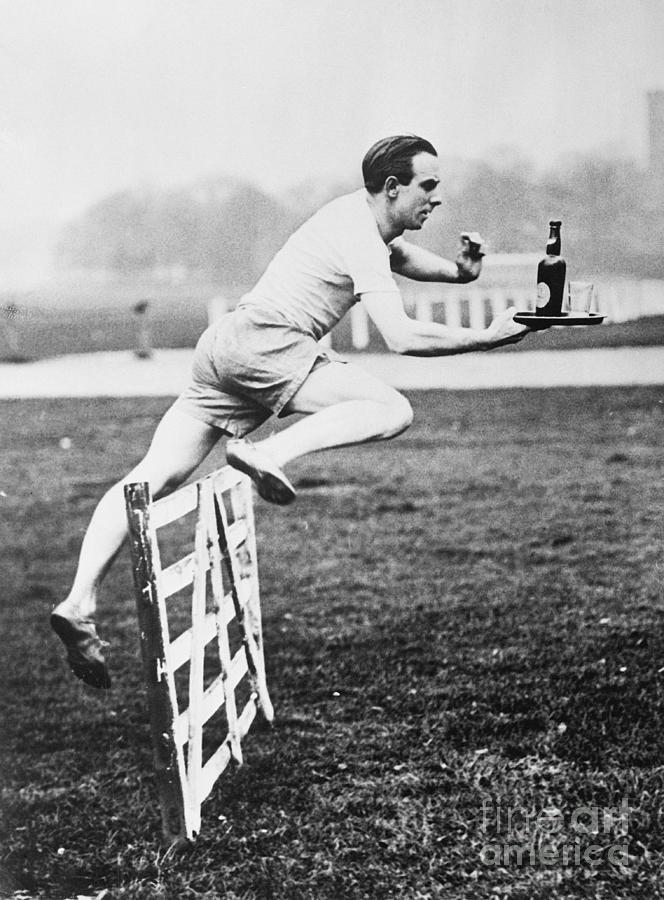 P. Hodge Jumping Over A Hurdle Photograph by Bettmann