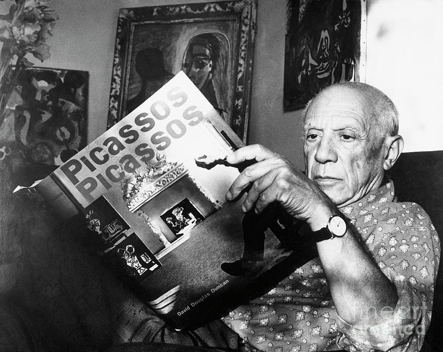 Pablo Picasso Thumbs Through Book Photograph by Bettmann