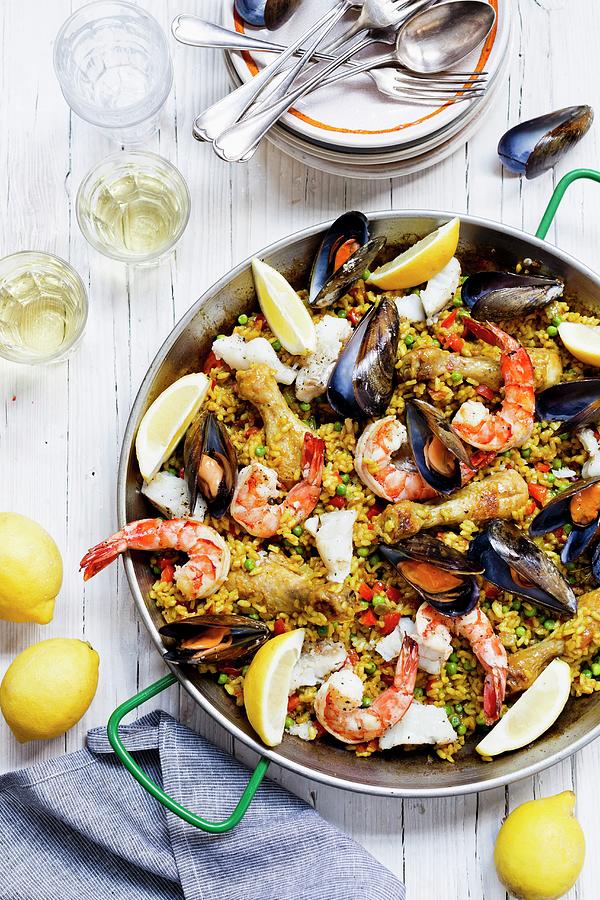 Paella With Seafood, Chicken And Lemons Photograph by Sporrer/skowronek