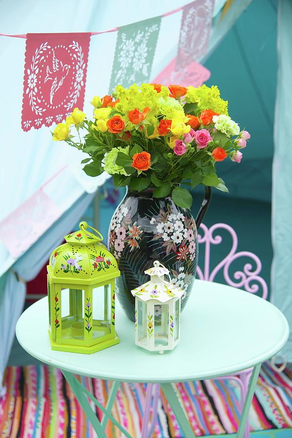 Painted Lanterns And Vase Of Colourful Summer Flowers On Garden Table Photograph by Winfried Heinze