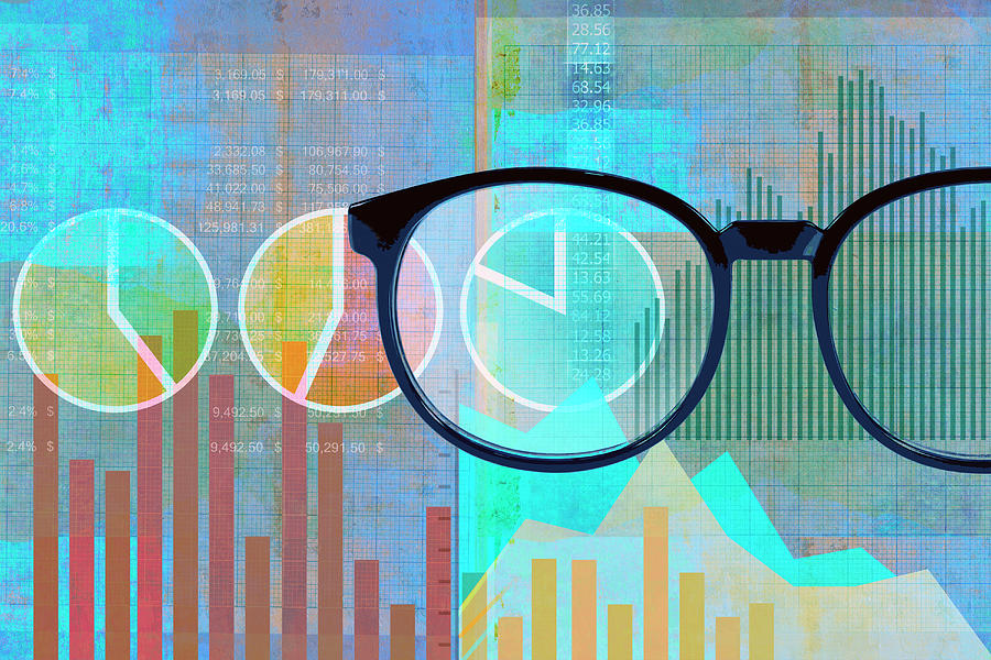 Pair Of Glasses Examining Financial Data Photograph by Ikon Images