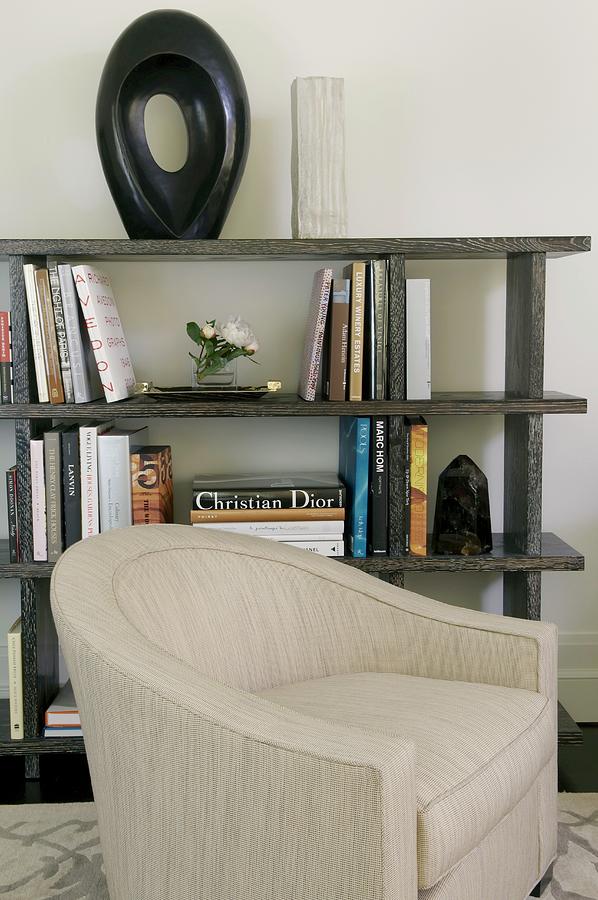 Pale Armchair In Front Of Half-height Bookcase Holding Books And Objet Photograph by Anastassios Mentis Photography