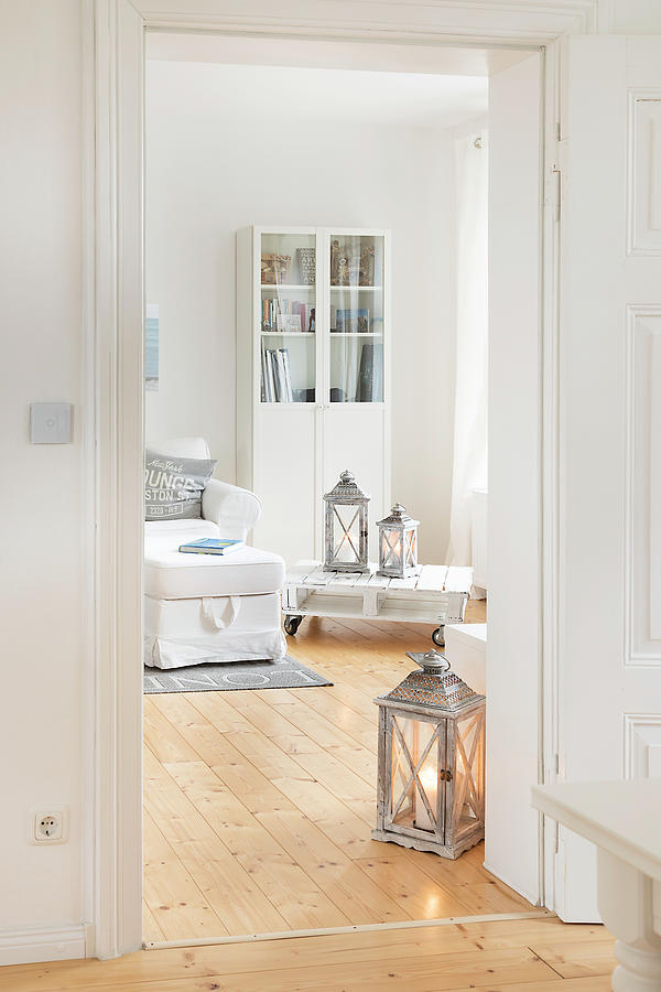 Pale Wooden Floor And White Furniture In Living Room Of Converted Dairy Photograph by Uwe Merkel