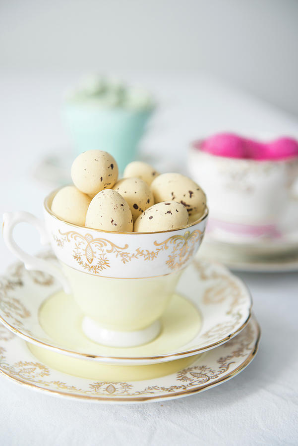 Pale Yellow Quail Eggs In Vintage Collectors Cup Photograph by Ruud Pos