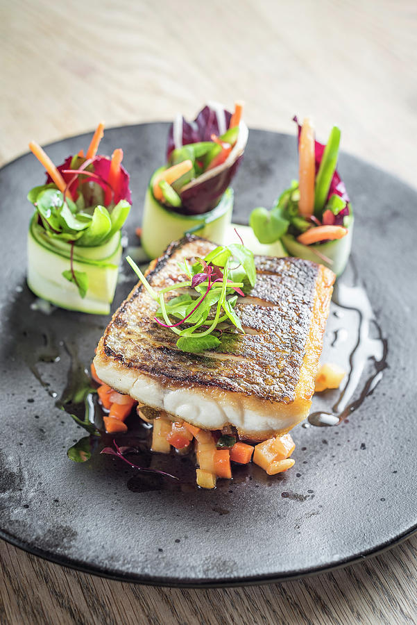 Fish Photograph - Pan Fried Sea Bass Fish Fillet On A Bed Of Diced Sauteed Vegetables And Pretty Vegetable Rolls by Giulia Verdinelli Photography