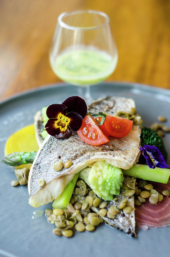 Pan Fried Sea Bass Fish Fillet On A Lentil, Broccoli, Beetroot, Asparagus, Tomatoes And Edible Flowers Salad Photograph by Giulia Verdinelli Photography