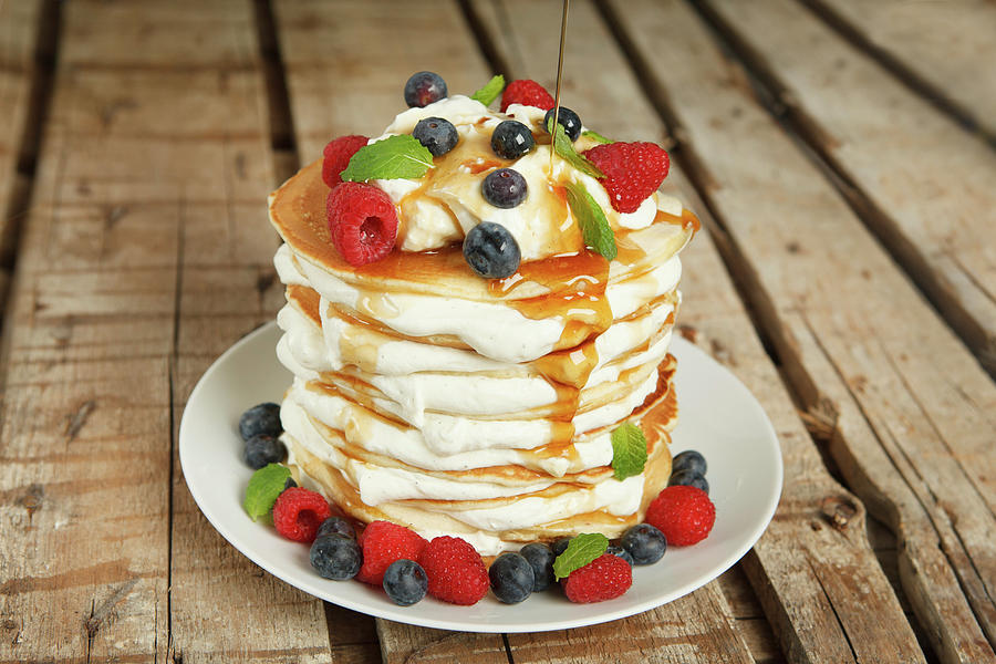 Pancake Cake With Orange Cream, Maple Syrup And Berries Photograph by Jalag / Intosite Kitchengirls