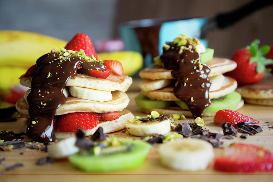 Pancakes With Kiwi, Strawberries, Banana, Chocolate And Pistachios Photograph by Albert Gonzalez