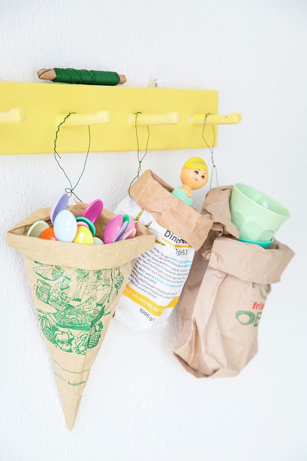 Paper Bags Reused To Store Plastic Spoons And Other Utensils Hung From Yellow Coat Rack By Florists Wire Photograph by Syl Loves