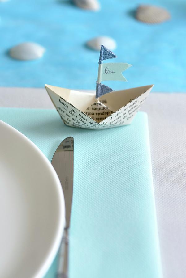Paper Boat With Name On Flag As Place Card Next To Place Setting Photograph by Sonia Chatelain
