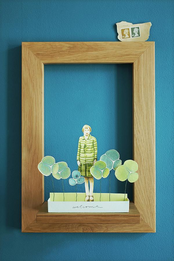 Paper Collage In Simple Oak Picture Frame On Blue Wall Photograph by Alexandra Loock