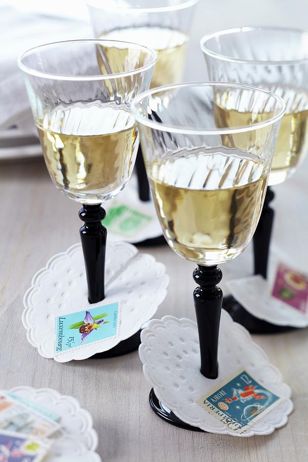 Paper Collars Decorated With Postage Stamps As Wine Glass Drip Catchers Photograph by Franziska Taube