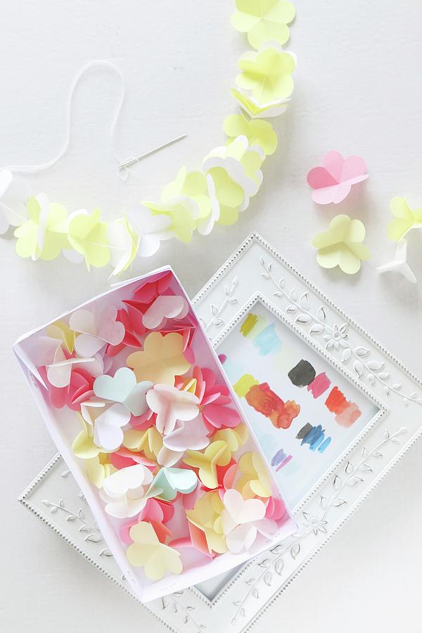 Paper Flowers In Box And Threaded On Garland Photograph by Regina Hippel