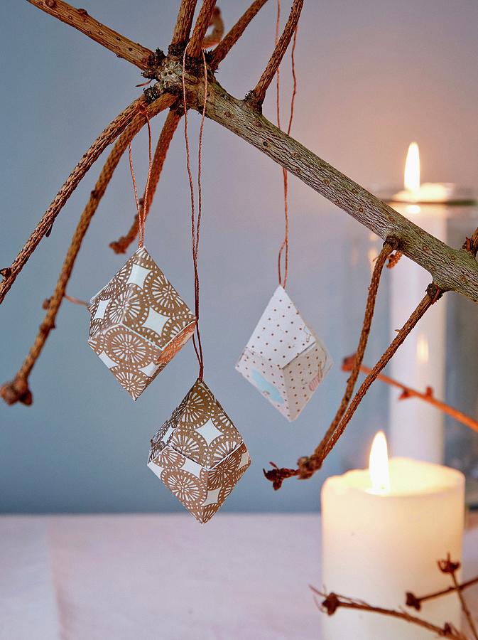 Paper Prisms Hung From Naked Fir Branch In Candlelight Photograph by Martin Slyst