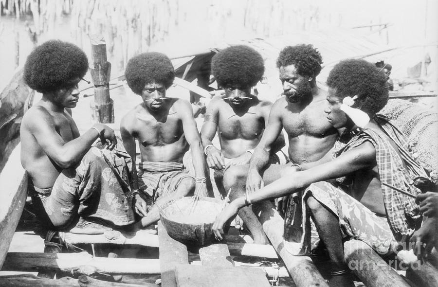 Papuan Men Eating Meal Photograph by Bettmann