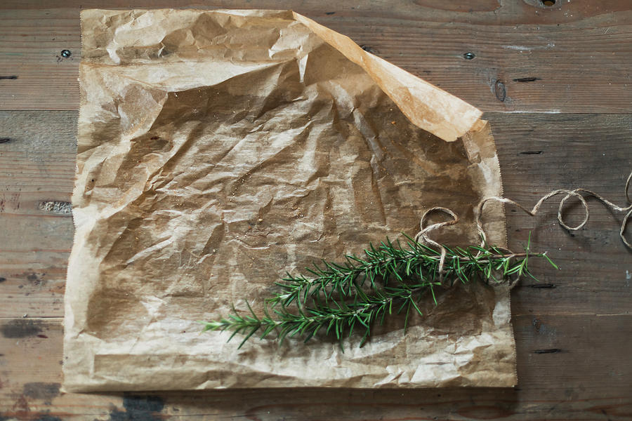 Parchment Paper And Fresh Rosemary Photograph by Pia Simon