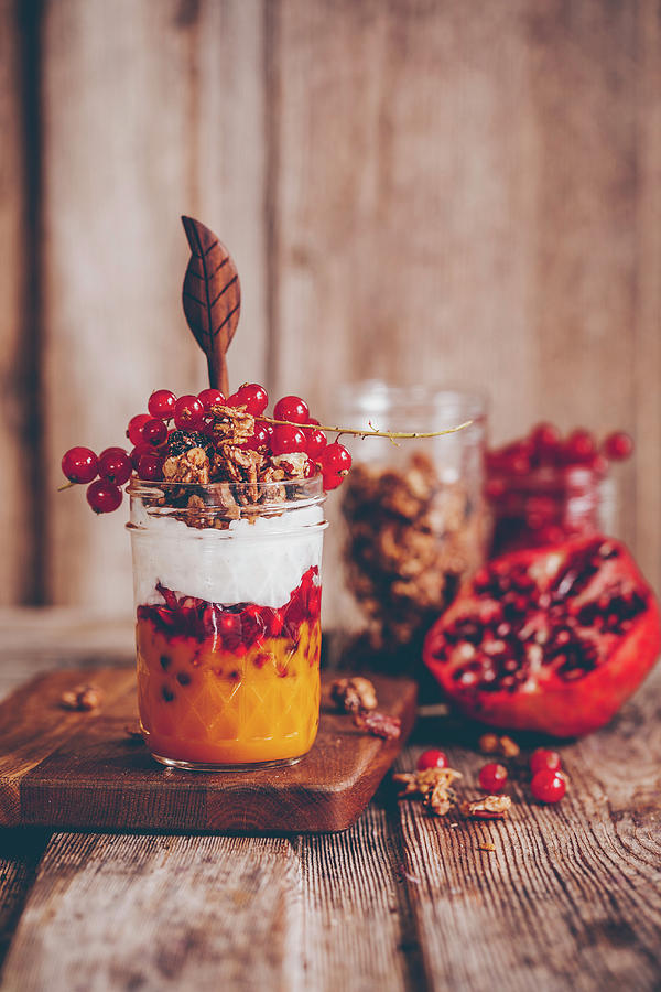 Parfait In A Glass With Mango Pure, Pomegranate Seeds, Coconut Yoghurt And Redcurrants Photograph by Freistyle