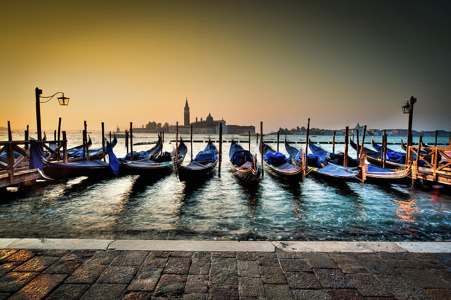 Parked gondolas, early morning in Venice, Italy. by Ian Robert Knight Parked gondolas, early morning in Venice, Italy. by Ian Robert Knight