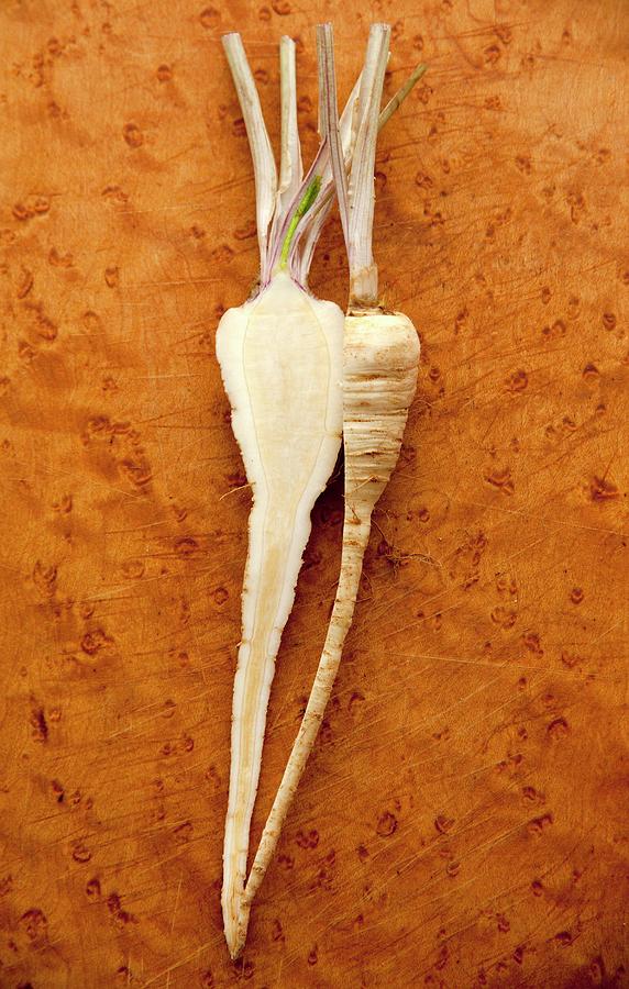 Parsley Root Halved On A Chopping Board Photograph by William Boch