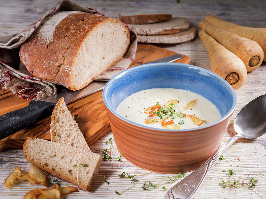 Parsnip Cream Soup With Garlic Chips, Cress And Rye Bread Photograph by Niklas Thiemann