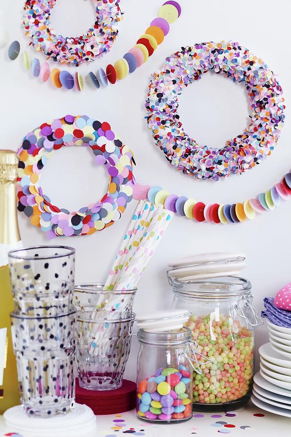 Party Buffet With Colourful Confetti Wreaths Decorating Wall Photograph by Franziska Taube