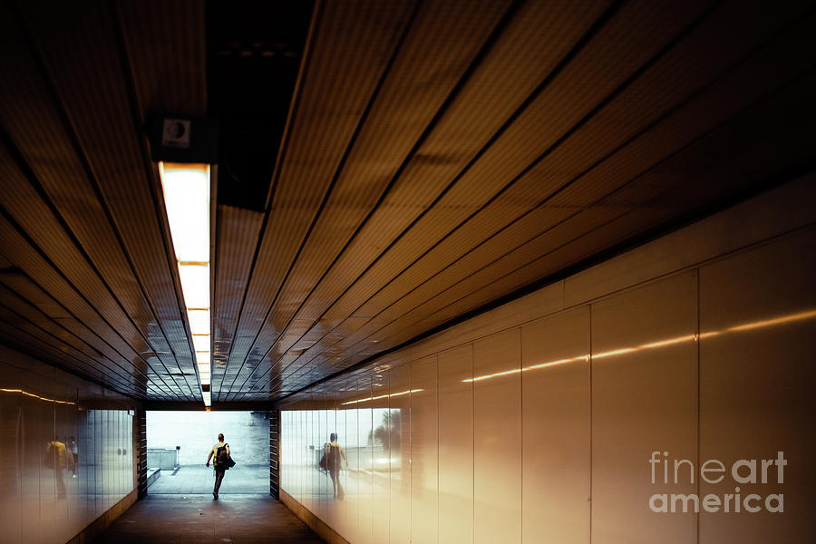 Passengers in a hurry at the end of a tunnel at the entrance to the metro station. Photograph by Joaquin Corbalan