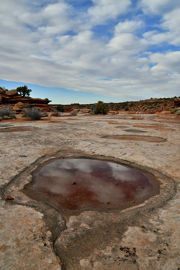Passing Clouds Reflected in Canyonlands Pool Photograph by Ray Mathis