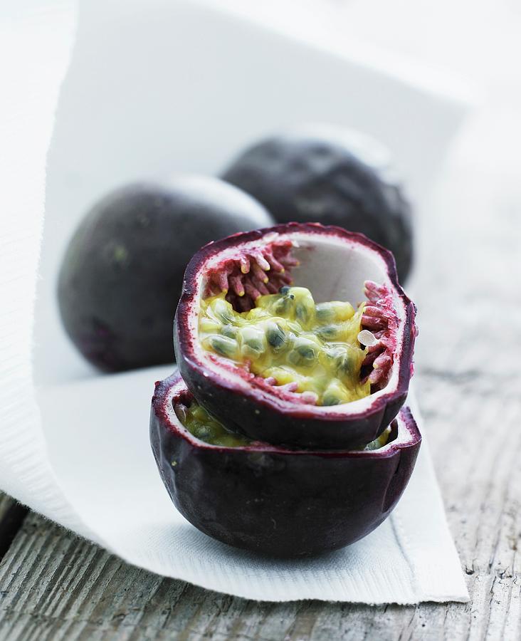 Passion Fruit On A White Cloth Photograph by Mikkel Adsbl