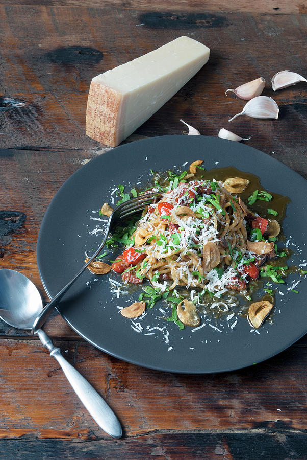 Pasta Dish With Mushrooms Tomatoes And Parmesan Cheese Photograph by Spyros Bourboulis