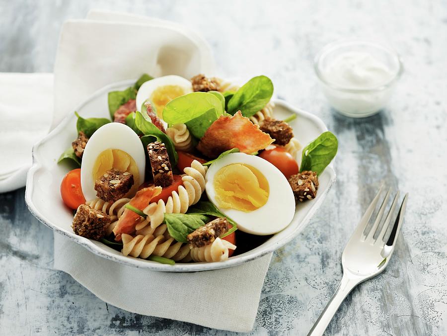 Pasta Salad With Hard Boiled Eggs, Bacon, Croutons And Tomatoes Photograph by Mikkel Adsbl