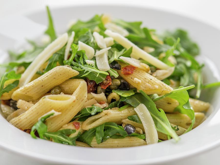 Pasta Salad With Rocket, Dried Tomatoes And Parmesan Cheese close-up Photograph by Manuel Krug