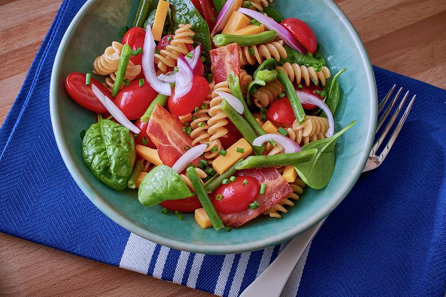 Pasta Salad With Tomatoes, Spinach And Bacon Photograph by Bernhard Winkelmann