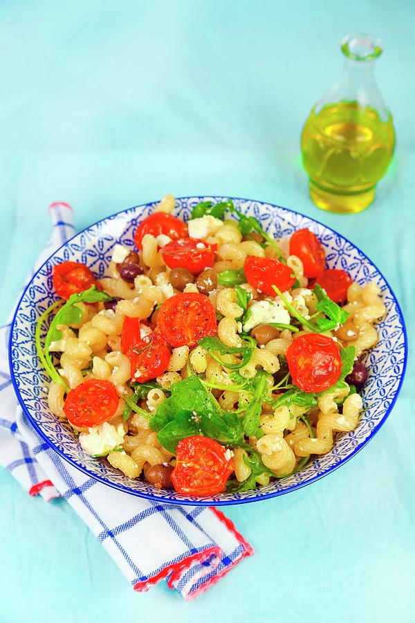 Pasta With Steamed Tomatoes, Feta Cheese, Olives And Rocket Photograph by Claudia Gargioni