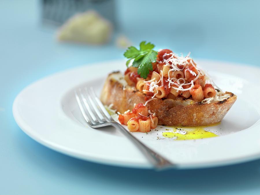Pasta With Tomato Sauce And Grated Cheese On Grilled Bread Photograph by Hugh Johnson