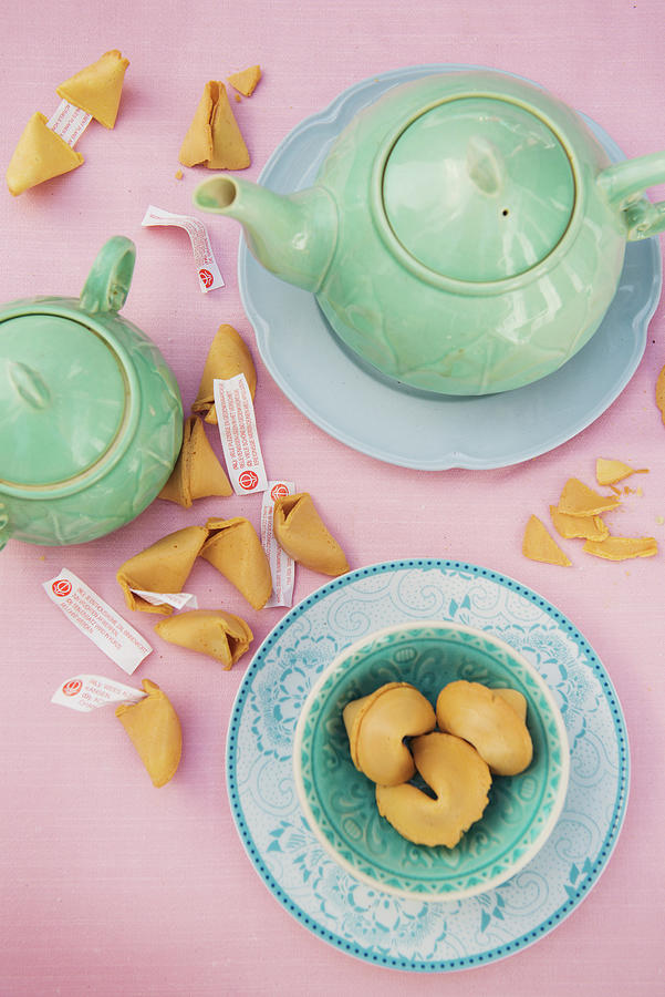 Pastel Blue Tea Crockery, A Teapot And Broken Fortune Cookies On A Pink Tablecloth Photograph by Benno De Wilde Photography