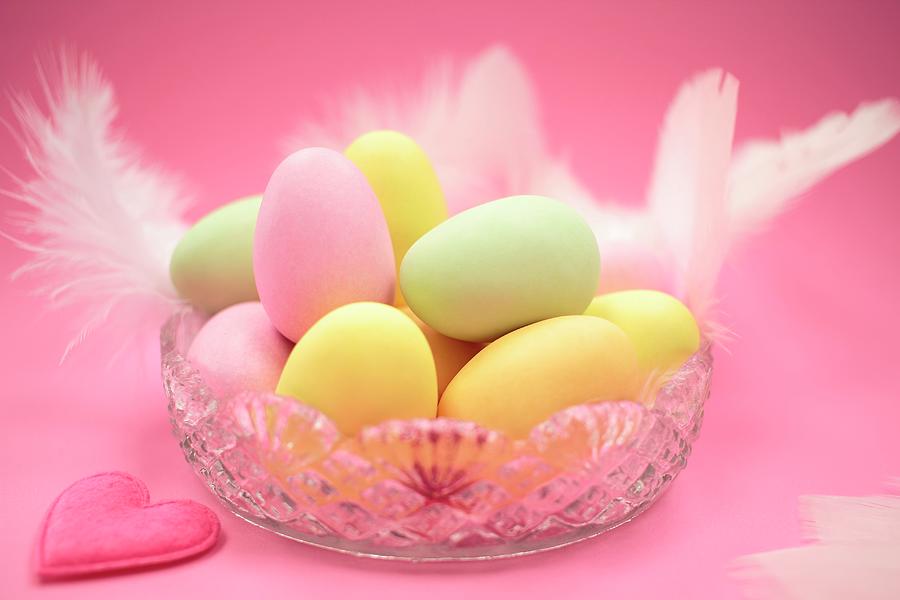 Pastel Coloured Easter Eggs With Feathers In A Glass Bowl Photograph by