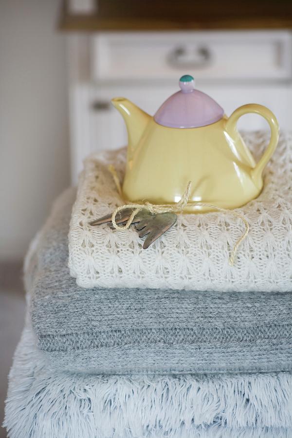 Pastel Teapot On Stack On Woollen Blankets Photograph by Alicja Koll