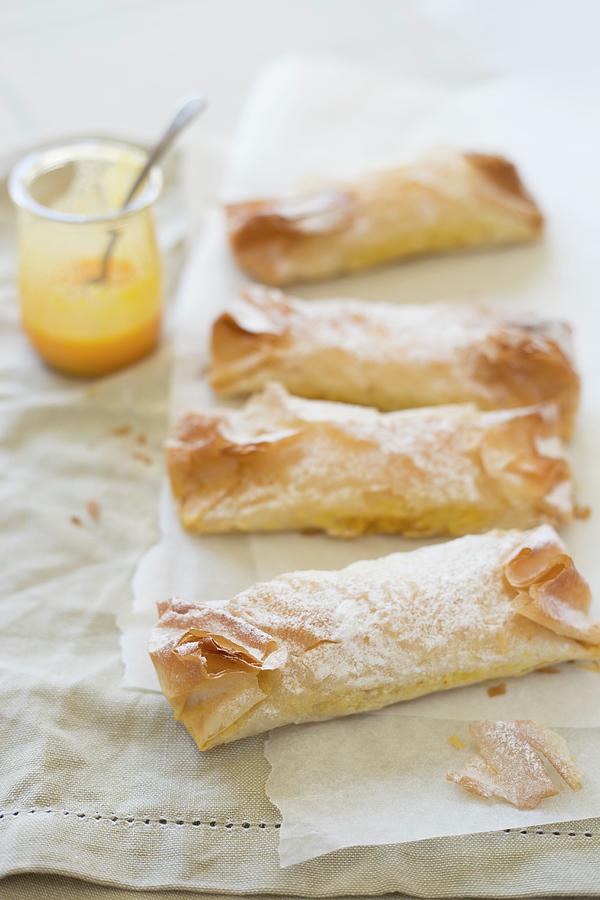 Pastis De Tentugal pudding-filled Pastry Rolls, Portugal On Parchment Paper Photograph by Joana Leito