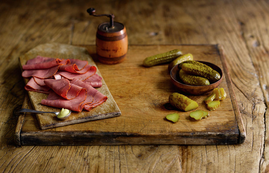 Pastrami And Gherkins On A Wooden Cutting Board Photograph by Gareth Morgans