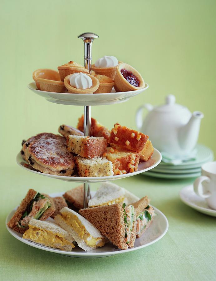 Pastries And Sandwiches On A Stand For Afternoon Tea Photograph by Jonathan Gregson