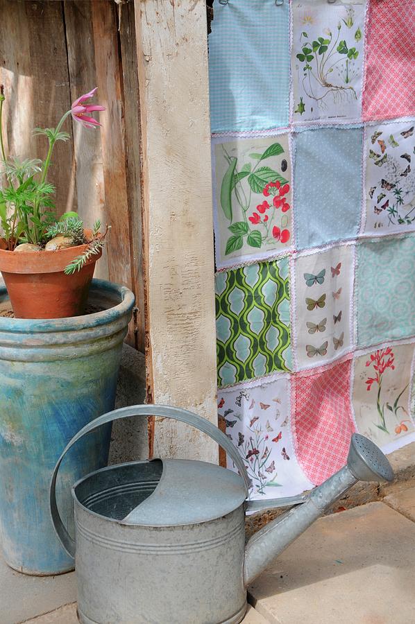 Patchwork Curtain Made From Fabric Remnants With Colourful Patterns And Vintage Prints Of Plants And Butterflies; Watering Can In Foreground Photograph by Revier 51