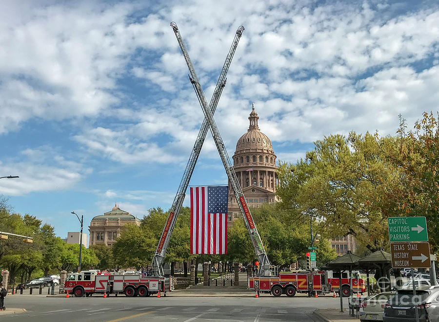 Austin Photograph - Patriotism shines bright as the US flag is hoisted by cranes on  by Dan Herron
