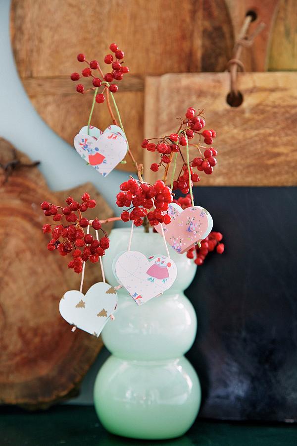 Patterned Paper Heart Pendants Hung From Branches Of Berries Photograph by Martin Slyst