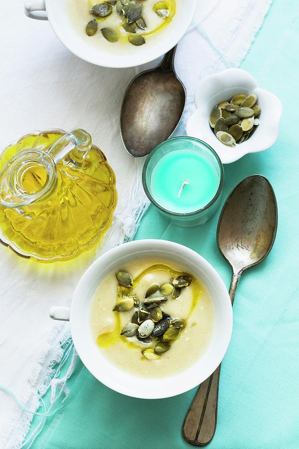 Patty Pan Squash Soup With Olive Oil And Pumpkin Seeds Photograph by Adel Bekefi
