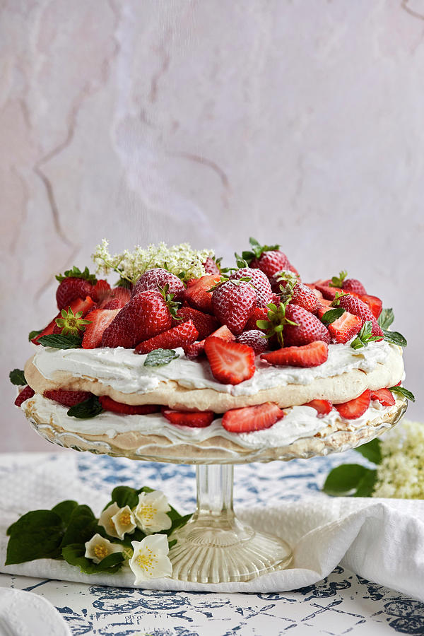 Pavlova Cake With Fresh Strawberries Garnished With Fresh Mint Leaves And Elderflower Photograph by Natasa Dangubic