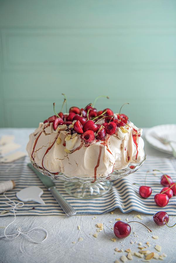 Pavlova With Cream, Almonds, Cherries And Cherry Sauce Photograph by Magdalena Hendey