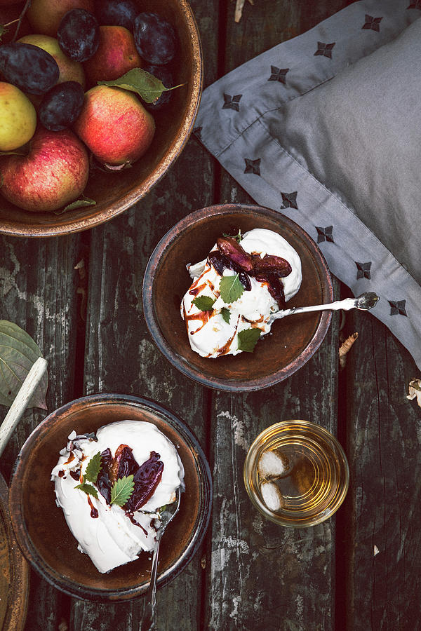 Pavlova With Whipped Cream And Spiced Plums In Cider Photograph by Claudia Gdke