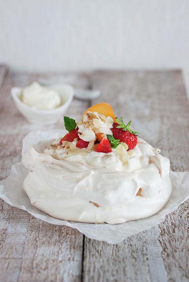 Pavlova With Whipped Cream, Fruit And Almonds Photograph by Valeria Aksakova