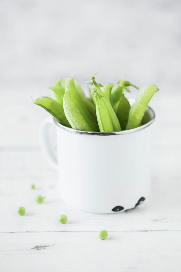 Pea Pods In An Enamel Mug Photograph by Malgorzata Laniak